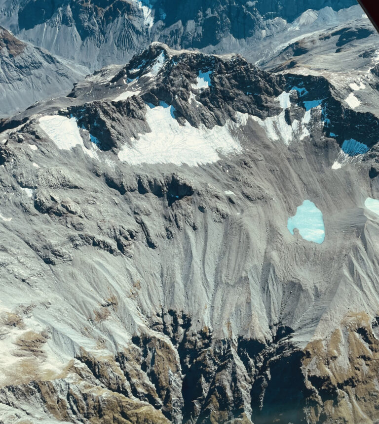 New Zealand’s glaciers appear “smashed and shattered” due to enduring ice loss, says NIWA A grey mountain with large portions of its glacier melted away.