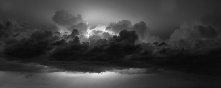 NOC reviews centuries of data on Europe’s long-term changes in storm patterns A black and white photo of gathered clouds with flashes of lightning.