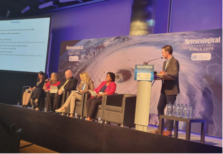 EXCLUSIVE FEATURE: How is the WMO developing more environmentally sustainable observing systems? A panel of five experts sit in front of an aerial shot of a hurricane with the words "Meteorological Technology World Expo" on it.