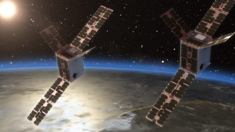 University of Bath to launch space weather sensors into orbit in 2027 Image of two satellites in space, orbiting the earth with the sun in the background.