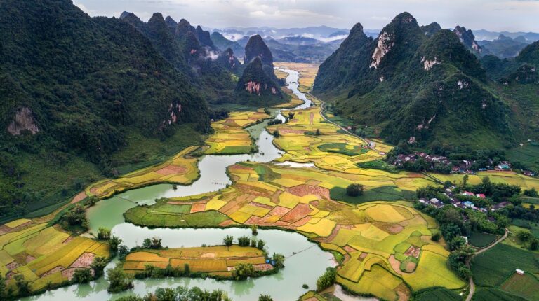 WMO adds image velocimetry to Guide to Hydrological Practices A river winds through a valley with sharp peaked ridges on either side