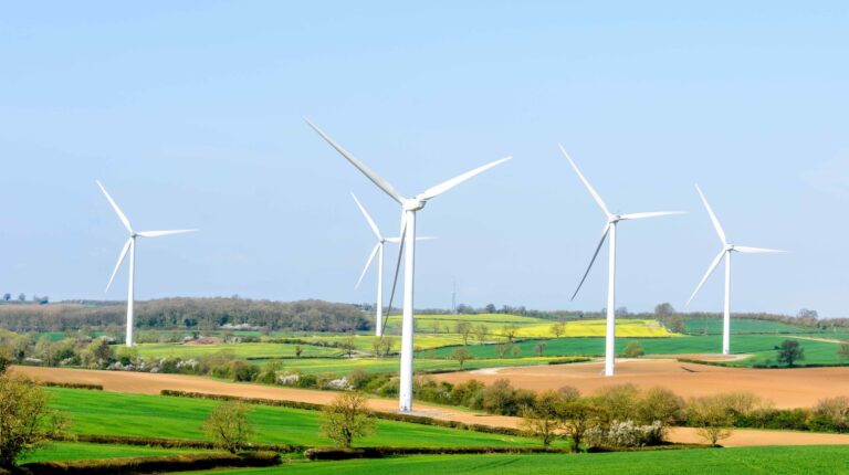 Royal Meteorological Society releases State of the Climate Report for the UK Energy Sector Three wind power turbines on a green field landscape