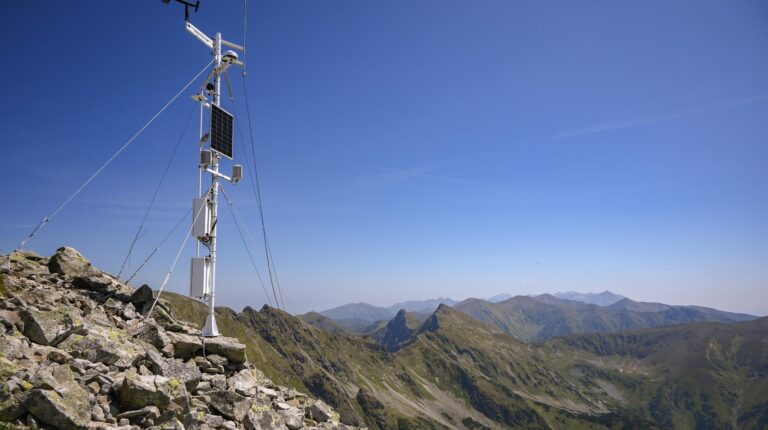 World’s first impact bond for weather and climate data opens for contributions An automated, remote weather instrument on a rocky outcrop in a mountain range, with a clear blue sky above.