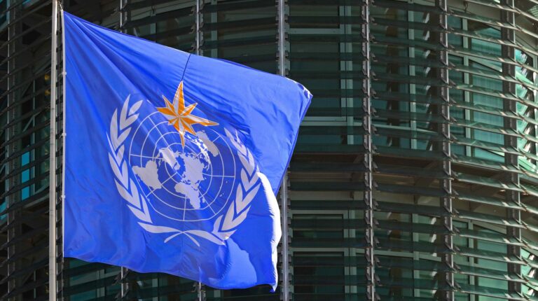 WMO launches digital transformation to boost global collaboration and knowledge sharing The flag of WMO - World Meteorological Organization in front of its headquarters building at the United Nations in Geneva, Switzerland