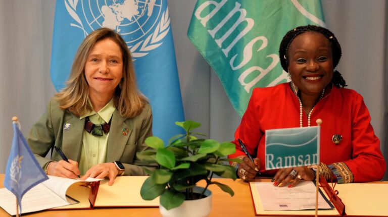 WMO and Convention on Wetlands sign cooperation agreement Celeste Saulo, secretary-general of the World Meteorological Organization (WMO) and Dr Musonda Mumba, secretary-general of the Convention on Wetlands (RAMSAR) sit at a table to sign a cooperation agreement. Image: WMO