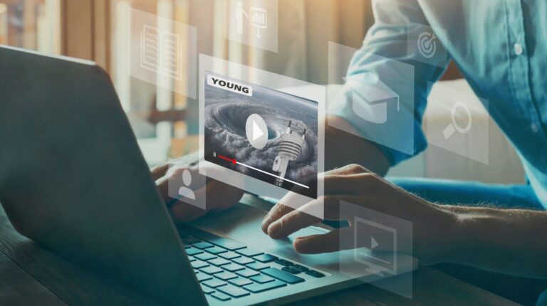 A person sat at a laptop with 3D images demonstrating the interactivity and connectivity it provides.