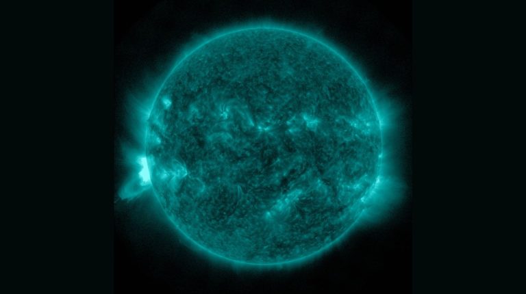 An image taken in 13.1nm light from the Atmospheric Imaging Assembly (AIA) onboard NASA’s SDO mission on October 14, 2014, showing the hot bright plasma (lower/left) from a long-duration M-flare. This flare came from NOAA Active Region 12192 when it was at least 20 degrees beyond the solar limb. Credit: NASA SDO/AIA