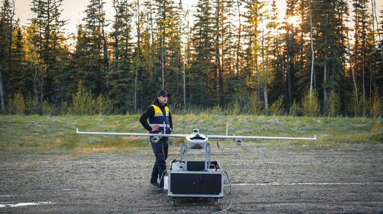 Tekever secures Canadian wildfire detection contract with Phoenix Heli-Flight A Tekever member of staff stands in front of the company's AR3 VTOL uncrewed aerial system in a forest.