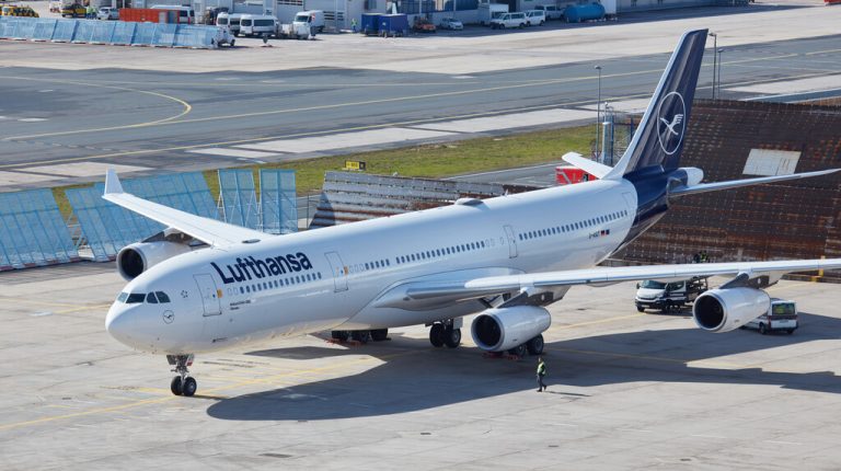 A Lufthansa Airbus taxiing on the tarmac at an airport.