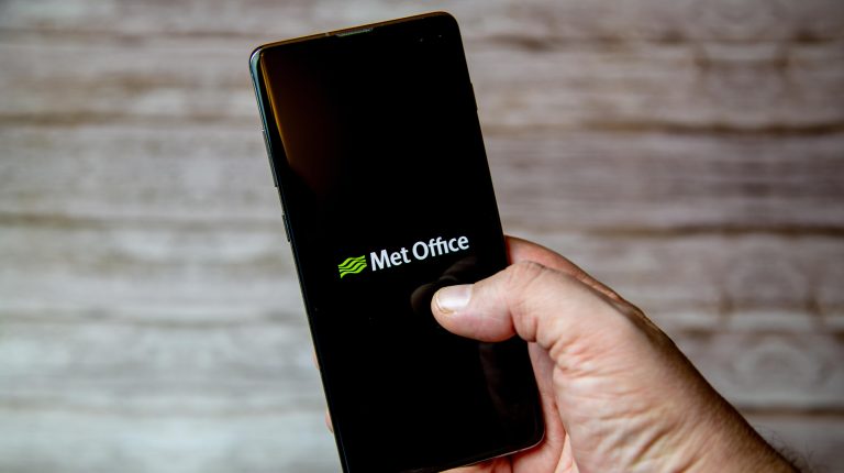 Met Office and British Red Cross launch website tool to boost extreme heat resilience 02-04-2021 Portsmouth, Hampshire, UK A handing holding a Mobile phone or cell phone with the Met Office weather app on screen.