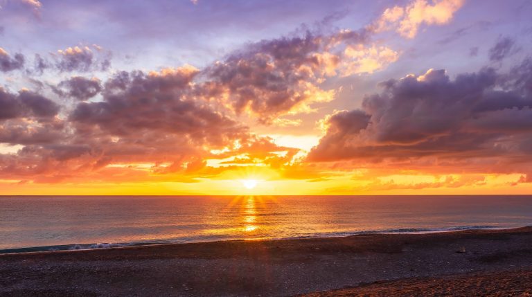 Dramatic seascape of sunset or sunrise sky with clouds during morning or evening.